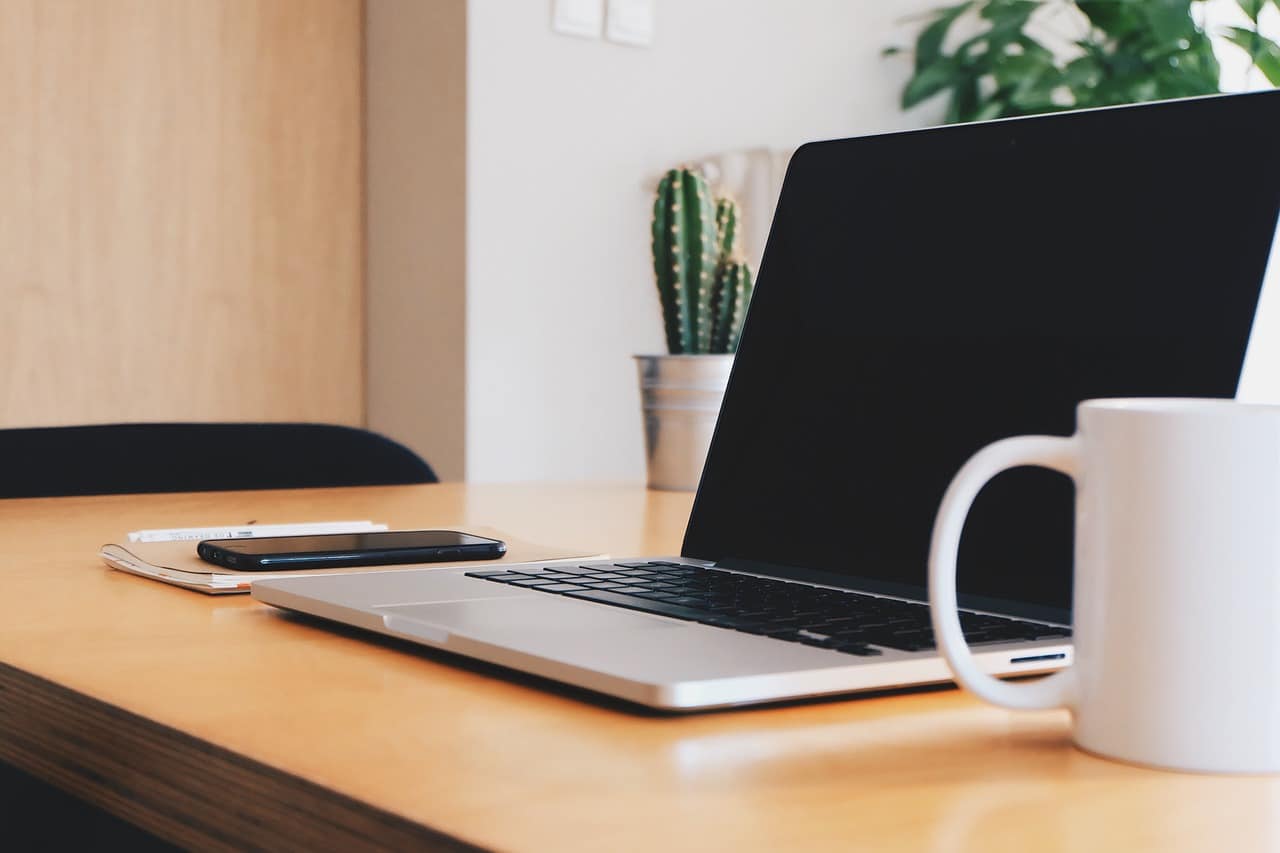 Laptop on a workspace desk. This laptop is protected by Disaster Recovery encompasses Cloud Backup, supporting an organization with resuming mission-critical functions quickly in the event of an unforeseen incident.