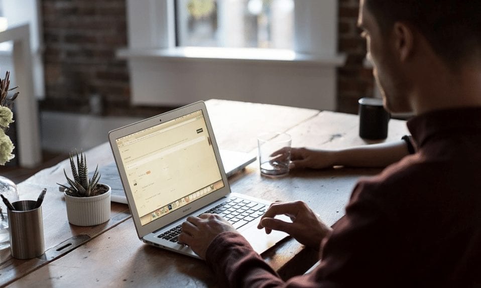 Remote employee working on laptop with Microsoft applications supported by SQL server 2008