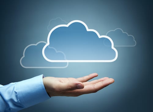 Business leader's hand beneath a cloud, symbolizing Cloud Solution Provider (CSP) licensing.